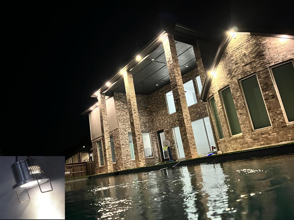 back yard pool and home façade outdoor lighting shining over water installed by ITEK on Richmond, TX home